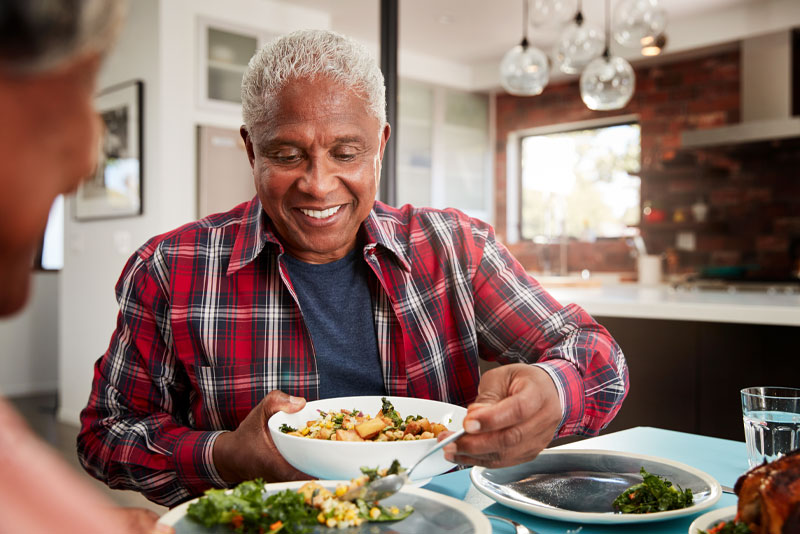 a dental implant patient eating a meal after tooth replacement.